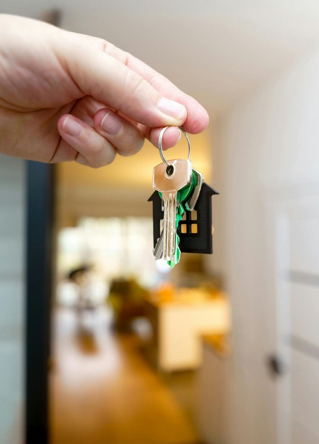 Hand holding house keys - your path to homeownership